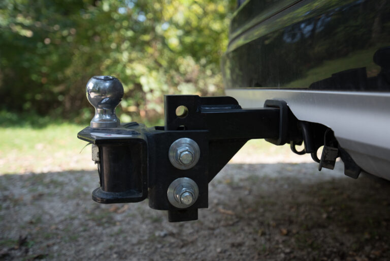 Close-up of a weight-distribution trailer tow hitch attached to a vehicle
